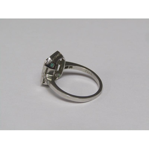 140 - A platinum emerald (0.9ct) and diamond (total 0.5ct) cluster ring, size N/O.