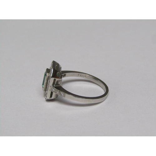 140 - A platinum emerald (0.9ct) and diamond (total 0.5ct) cluster ring, size N/O.