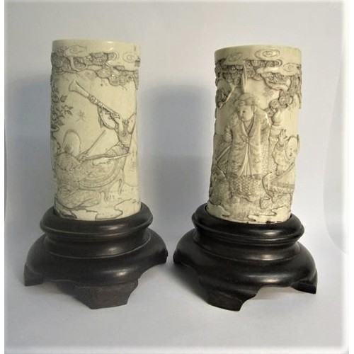 73 - A pair of Japanese ivory vases carved with a scene of Shoulao seated and with children and attendant... 