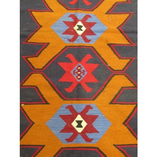 1803 - ORIENTAL RUG OF GEOMETRIC PATTERN BEING ORANGE BLUE AND FAWN GROUND 175 x 99 cms