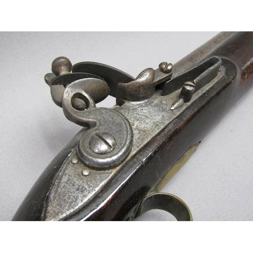 23 - A sixteen bore flintlock pistol of military style, proof marks. The lock stamped 1812, the barrel wi... 