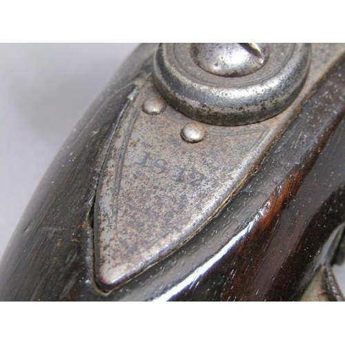 23 - A sixteen bore flintlock pistol of military style, proof marks. The lock stamped 1812, the barrel wi... 