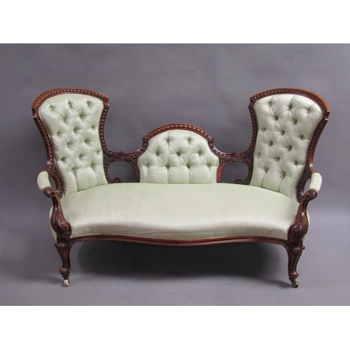 293 - A Victorian walnut show framed and upholstered double end sofa of serpentine form, the framed carved... 