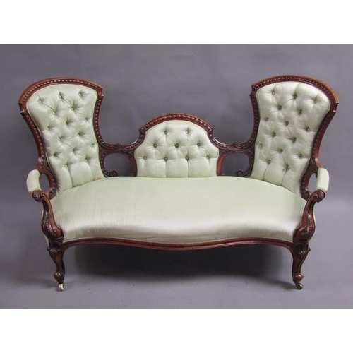 293 - A Victorian walnut show framed and upholstered double end sofa of serpentine form, the framed carved... 