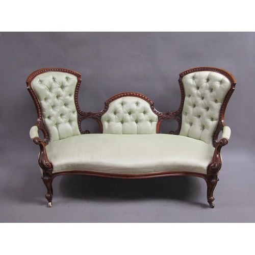 293 - A Victorian walnut show framed and upholstered double end sofa of serpentine form, the framed carved... 