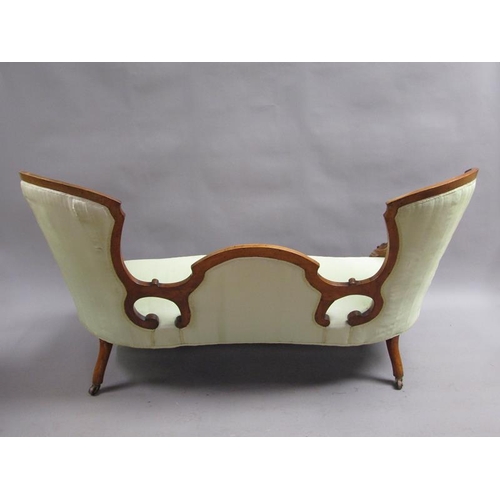 293 - A Victorian walnut show framed and upholstered double end sofa of serpentine form, the framed carved... 