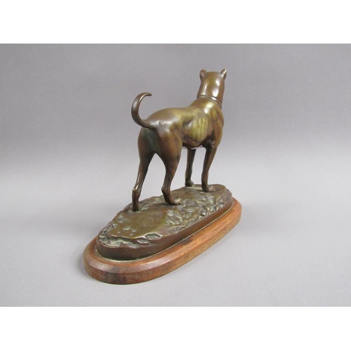 40 - A 20c patinated bronze figure of a terrier dog, standing, and supported on a wooden base, 20cm w, 17... 