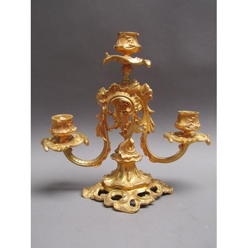42 - A pair of 19c gilt metal two branch rococo style candelabrum with impressed marks 'EM 23', 24cm w, 2... 
