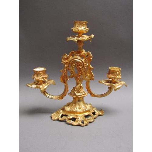 42 - A pair of 19c gilt metal two branch rococo style candelabrum with impressed marks 'EM 23', 24cm w, 2... 