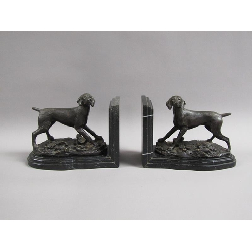 43 - A pair of late 19c black patinated metal gun dog book ends, the pointer dogs on rocky bases with imp... 