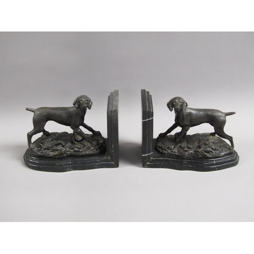 43 - A pair of late 19c black patinated metal gun dog book ends, the pointer dogs on rocky bases with imp... 