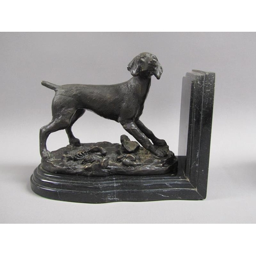 43 - A pair of late 19c black patinated metal gun dog book ends, the pointer dogs on rocky bases with imp... 
