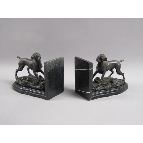 43 - A pair of late 19c black patinated metal gun dog book ends, the pointer dogs on rocky bases with imp... 