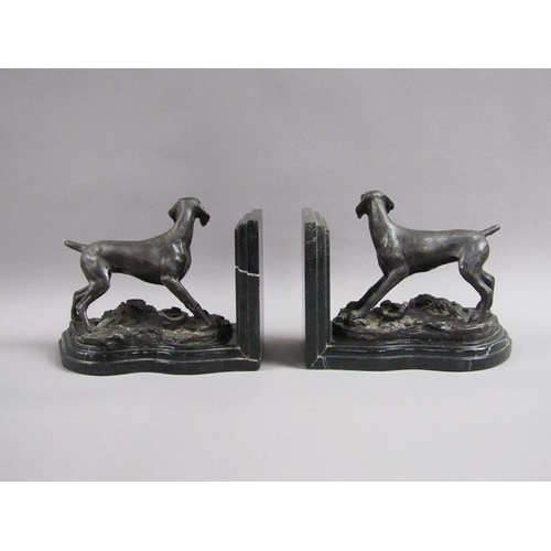 43 - A pair of late 19c black patinated metal gun dog book ends, the pointer dogs on rocky bases with imp... 