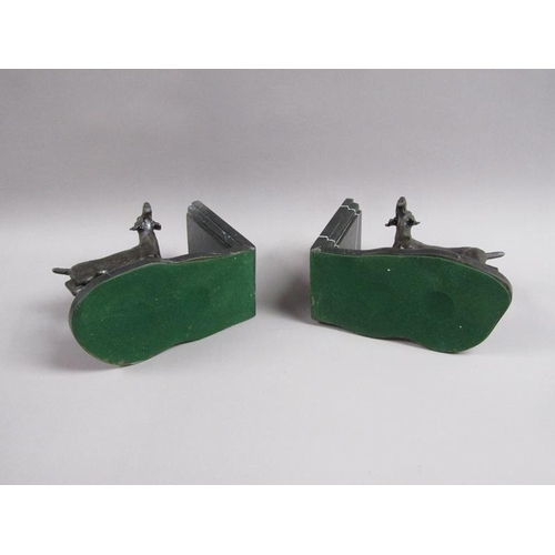 43 - A pair of late 19c black patinated metal gun dog book ends, the pointer dogs on rocky bases with imp... 