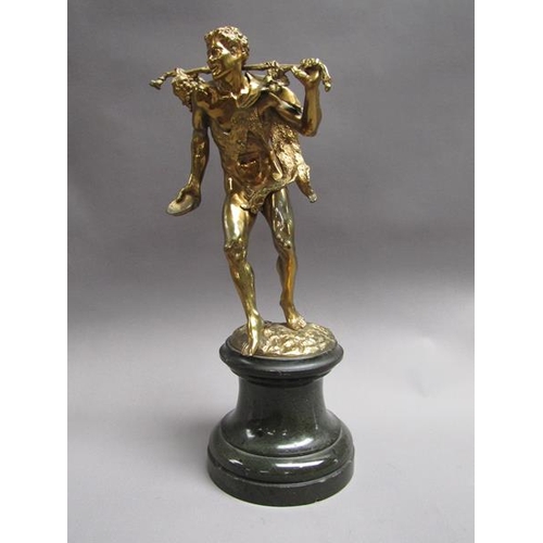 46 - A late 19c gilt metal figure of mythological traveller wearing animal skin with staff and bunch of g... 
