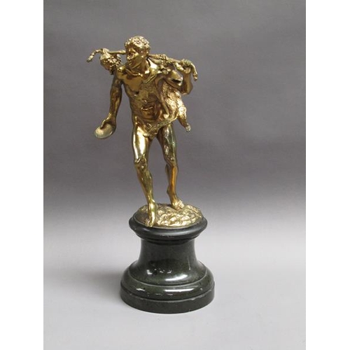 46 - A late 19c gilt metal figure of mythological traveller wearing animal skin with staff and bunch of g... 