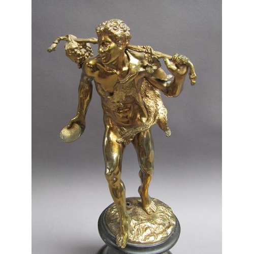 46 - A late 19c gilt metal figure of mythological traveller wearing animal skin with staff and bunch of g... 