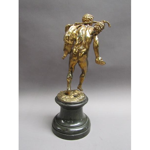 46 - A late 19c gilt metal figure of mythological traveller wearing animal skin with staff and bunch of g... 