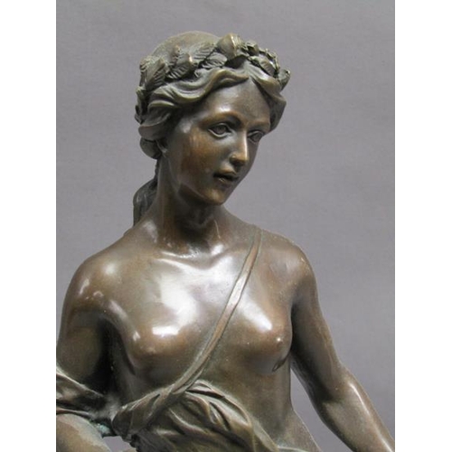 47 - A 19c French patinated bronze figure of a classical female with a spray of leaf and roses in her lef... 