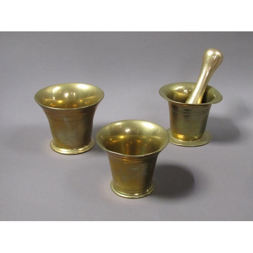 54 - A late 18c/early 19c bronze mortars and a pestle, the mortars, 12.5cm, 13cm & 14cm diam mouths, and ... 