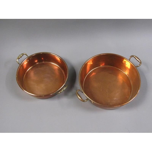 55 - Two 19c copper and brass two handled pans, 40cm & 35cm diam, 7cm & 13cm deep.