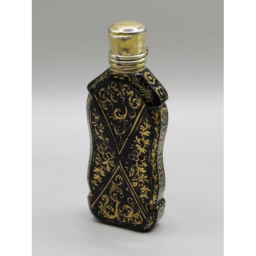 72 - A 19c glass scent bottle of facet form with panels of gilt work and having a gilt metal hinged top, ... 