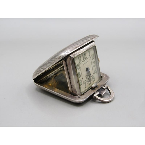 73 - A small Swiss travelling clock in folding silver case made by Sapho and retailed by Elkingtons.  The... 