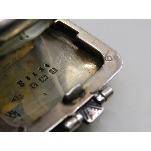 73 - A small Swiss travelling clock in folding silver case made by Sapho and retailed by Elkingtons.  The... 