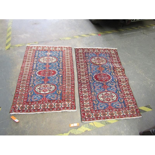 1973 - TWO ORIENTAL RED AND BLUE GROUND RUNNERS, 113CM X 69CM & 105CM X 75CM