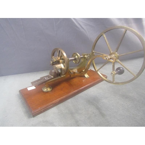 1361 - CAST BRASS WINDER ON WOODEN BASE, 43cms W