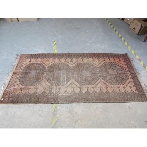 1959 - ORIENTAL BROWN AND FAWN GROUND WOOLLEN RUG, 104cm x 226cm