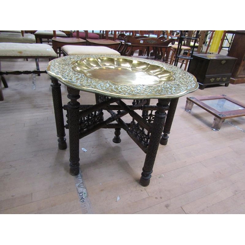 1894 - 19C ORIENTAL BRASS TRAY TOP TABLE WITH CARVED WOOD FOLDING FRAME, 52CM H