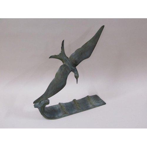 1444 - An early 20c green patinated bronze figure of a flying sea bird over water, inscribed and by G. Garr... 