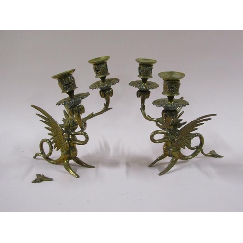 1450 - A pair of late 19c brass griffin two branch candelabrum, 22cm h, a/f.