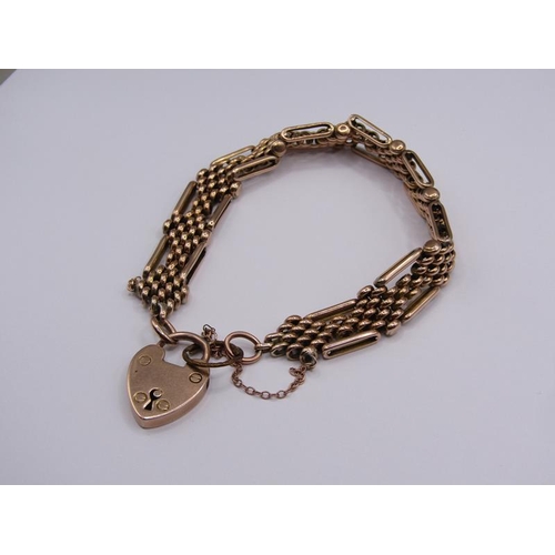 1545 - A 9ct gold bead and gate bracelet with padlock, 24.8g.