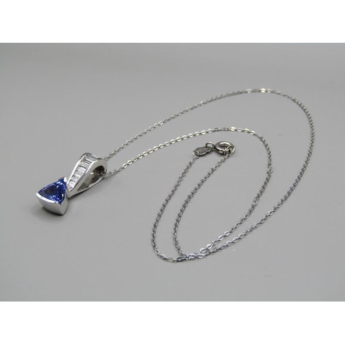 1594 - A tanzanite and baguette diamond 14ct white gold pendant on a 18ct white gold chain.