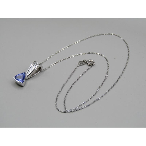 1594 - A tanzanite and baguette diamond 14ct white gold pendant on a 18ct white gold chain.