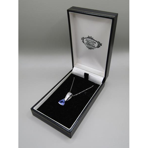 1594 - A tanzanite and baguette diamond 14ct white gold pendant on a 18ct white gold chain.