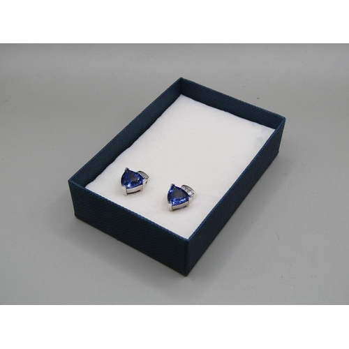 1595 - A pair of 14ct gold tanzanite and baguette diamond set earrings.