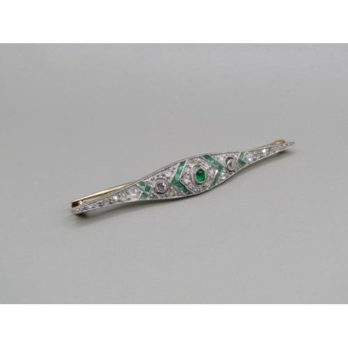 1605 - A gold diamond and emerald set bar brooch, 5.5cm w.