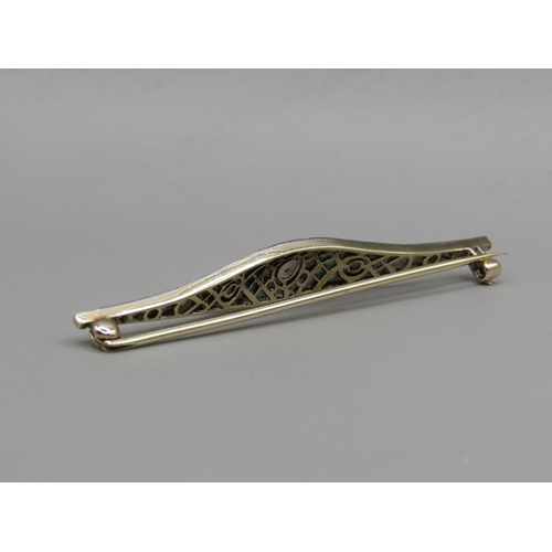 1605 - A gold diamond and emerald set bar brooch, 5.5cm w.