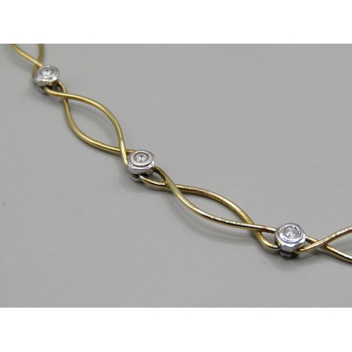 1615 - An 18ct yellow and white gold necklet, diamond set together with a pair of matching earrings.