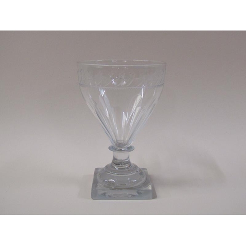 1863 - A late 18c rummer glass with ogee bowl, feather engraved border rim, half facet cut on a short plain... 