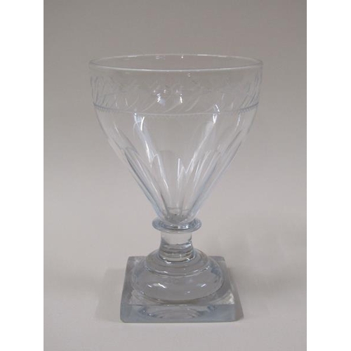 1863 - A late 18c rummer glass with ogee bowl, feather engraved border rim, half facet cut on a short plain... 