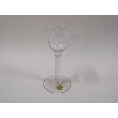 1868 - A mid 18c wine glass with ogee bowl, engraved with a border of leaf and flowers, the stem with white... 