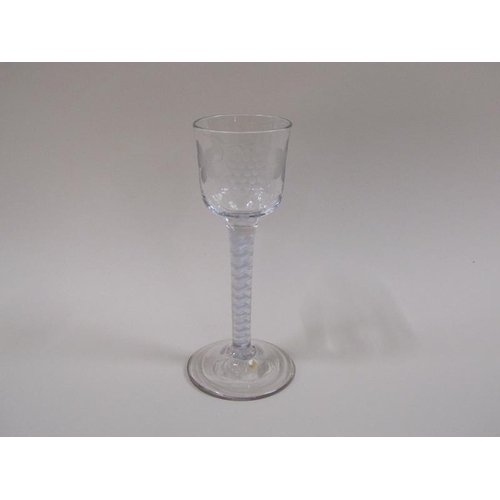 1869 - A mid 18c wine glass, the ogee bowl engraved with a border of fruiting vine and a flying bird, on a ... 