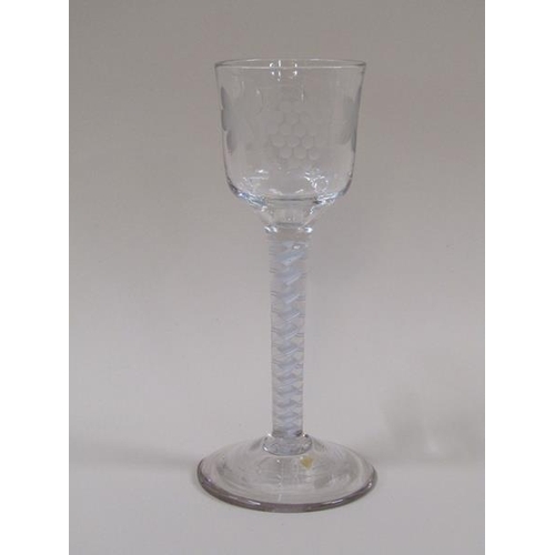 1869 - A mid 18c wine glass, the ogee bowl engraved with a border of fruiting vine and a flying bird, on a ... 