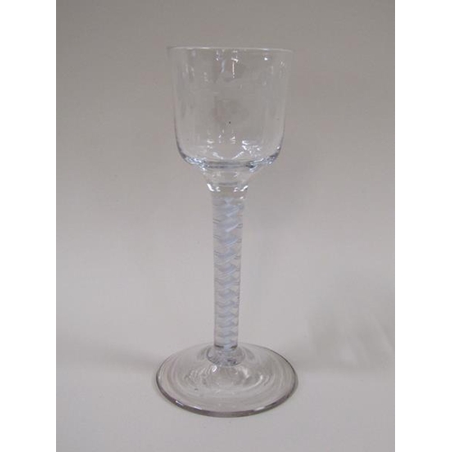 1869 - A mid 18c wine glass, the ogee bowl engraved with a border of fruiting vine and a flying bird, on a ... 