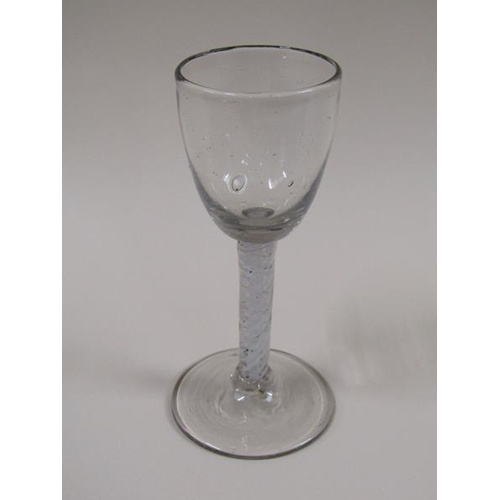 1873 - A mid 18c wine glass with an ogee bowl and a double series opaque twist stem on a slightly dome foot... 